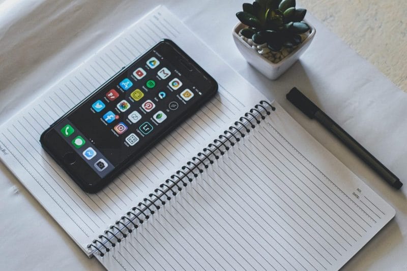 Phone in the notebook and a Pen, digital marketing agency singapore